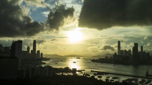 Buildings are silhouetted as the sun sets in Hong Kong, China, on Thursday, June 4, 2020. Hong Kong is facing renewed tensions following months of unprecedented pro-democracy protests that kicked off soon after last June's vigil. Demonstrations have again increased in recent weeks as China announced that it would impose sweeping national security legislation on the city, raising concerns about whether it would maintain key freedoms from the mainland. Photographer: Justin Chin/Bloomberg