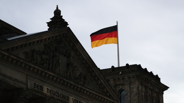 The German national flag flies above the Reichstag building as Germany takes over the European Union’s rotating six-month presidency, in Berlin, Germany, on Wednesday, July 1, 2020. For a leader who has steered Europe through two economic meltdowns, a migration crisis and a simmering showdown with Russia, Angela Merkel’s final act as German chancellor may be her biggest performance yet. Photographer: Krisztian Bocsi/Bloomberg