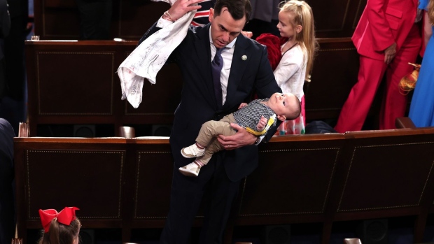 Rep. Rob Menendez Jr., a Democrat from New Jersey, holds his son as his daughter sits near by, during the first day of the 118th Congress at the US Capitol.