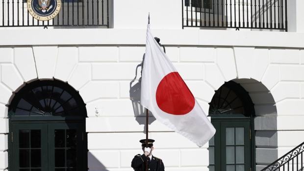 A member of the honor guard holds a Japanese national flag ahead of a visit by Fumio Kishida, Japan's prime minister, on the South Lawn of the White House in Washington, DC.
