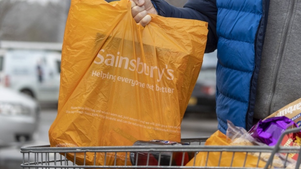 A shopper removes bags from a trolley outside a J Sainsbury Plc supermarket in Godalming, UK, on Tuesday, Jan. 10, 2023. Sainsbury's are due to release a trading update on Wednesday. Photographer: Jason Alden/Bloomberg