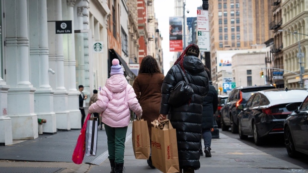 Shoppers carry T.J. Maxx bags in the SoHo neighborhood of New York, US, on Saturday, Jan. 21, 2023. The Bureau of Economic Analysis is scheduled to release personal spending figures on January 27. Photographer: Jordana Bermudez/Bloomberg