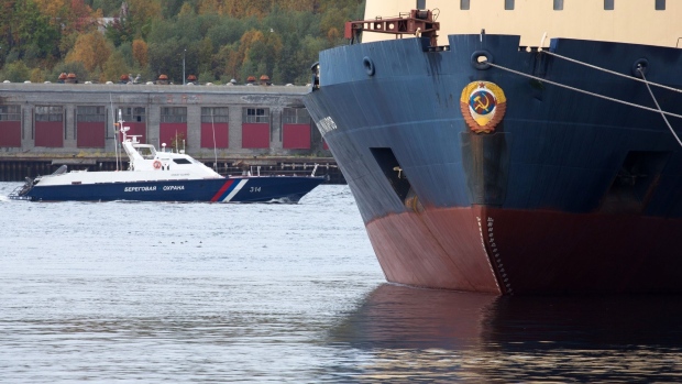 The Admiral Makarov icebreaking ship, right, operated by Fesco Transportation Group (FESCO), sits moored at the dockside at the Port of Murmansk, in Murmansk, Russia, on Saturday, Sept. 14, 2019. Crude and condensate shipments from Russia’s Arctic terminals are shipped in dedicated shuttle tankers to the Russian port of Murmansk where they are trans-shipped onto larger vessels for export.