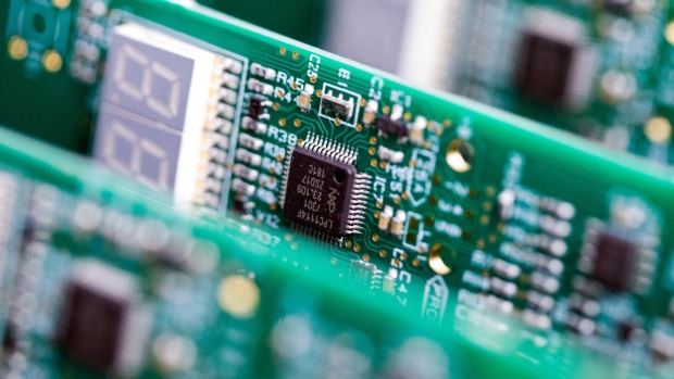 An NXP Semiconductors integrated circuit microchip (IC) on a circuit board. Photographer: Chris Ratcliffe/Bloomberg