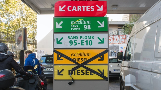 A sign indicates that diesel is unavailable as customers queue for fuel at a TotalEnergies SE gas station in Paris, France, on Friday, Oct. 7, 2022. The French government may release additional strategic fuel stocks to ease shortages caused by a refinery strike that has drained gas stations in some regions.