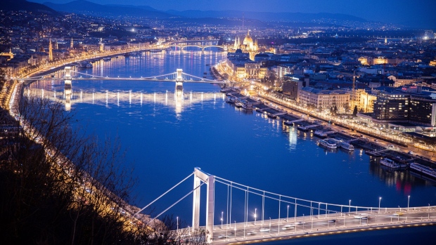 Lights illuminate the city skyline and the Chain Bridge at night in Budapest, Hungary, on Tuesday, March 9, 2021. Prime Minister Viktor Orban severely tightened curbs, closing schools and nearly all retail outlets from Monday. Photographer: Akos Stiller/Bloomberg