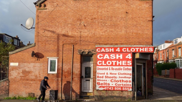 A sign outside a shop advertises cash for clothes in Leeds. Photographer: Dominic Lipinski/Bloomberg