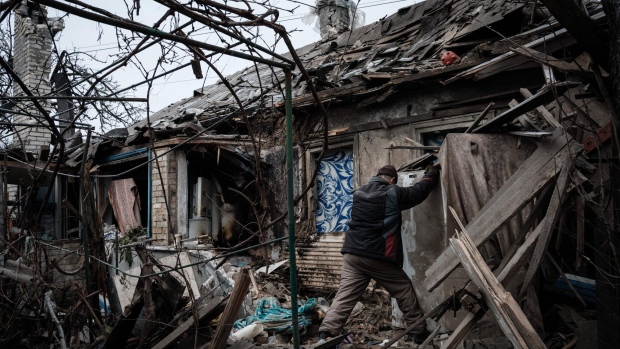 Oleksandr Pykhtin (L), 73, tries to open a refrigerator at his house destroyed by a rocket last night as the sounds of gunshots and artillery continue in the distance in Chasiv Yar on January 28, 2023. Photographer: Yasuyoshi Chiba/AFP/Getty Images