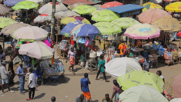 Vendors stalls set up under umbrellas for protection from the sun at the Kaneshie Market Complex in Accra, Ghana, on Wednesday, Nov. 30, 2022. With debt interest payments eating up more than half of government revenues Ghana has asked the IMF for a $3 billion bailout, proposed a debt restructuring that could involve losses of up to 30% for foreign investors and is planning to barter some of the gold it produces for oil.