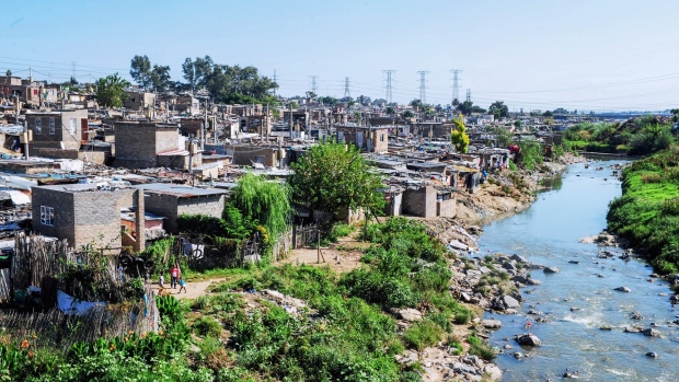 Informal housing on the banks of the river Jukskei river in the Alexandra township of Johannesburg, South Africa, on Wednesday, March 30, 2022. A campaign against foreigners is being led by Operation Dudula, an isiZulu word meaning “to push out.”, with the group carrying out raids on what it alleges are brothels, drug dens and trading stores run by foreigners in central Johannesburg and surrounding townships. Photographer: Leon Sadiki/Bloomberg