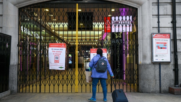 A traveller approaches closed gates at a station entrance, as train drivers represented by the Aslef union take part in strike action, at London Victoria railway station in London, UK, on Thursday, Jan. 5, 2023. Some of London's biggest railway stations are shut on Thursday while airports such as Gatwick are also deprived of any train services, as workers strike again and union bosses warn of more industrial action to come.