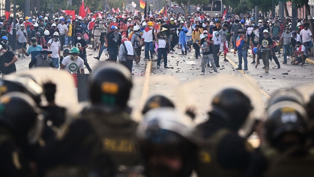 Demonstrators clash with riot police in Lima on Jan. 24.