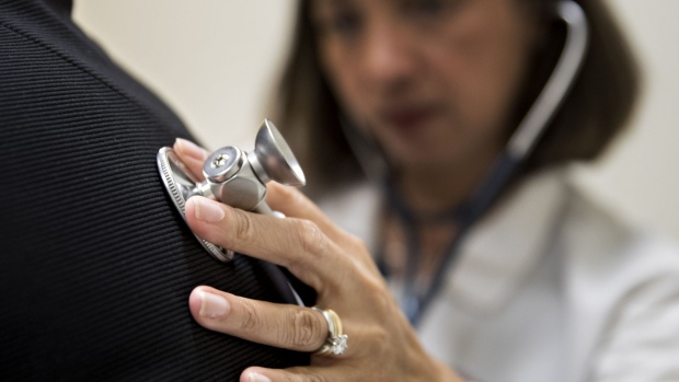 A medical doctor examines a patient with a stethoscope at a CCI Health and Wellness Services health center in Gaithersburg, Maryland, U.S., on Tuesday, April 18, 2017. After the failure of Republicans first attempt to repeal and replace the Affordable Care Act and President Donald Trumps subsequent threats to let the program explode, more health insurers are threatening to pull out of the Obamacare health-care program next year, while others may sharply raise the premiums they charge. Photographer: Andrew Harrer/Bloomberg