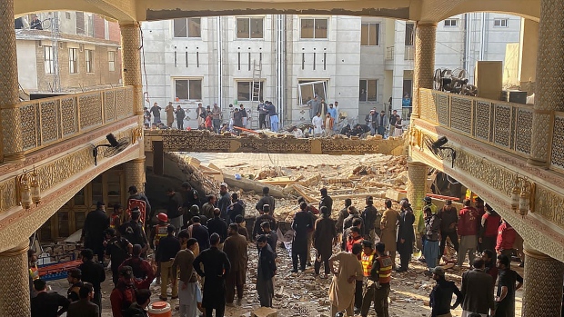 Security officials inspect the site of a mosque blast in Peshawar on Jan. 30. Photographer: Maaz Ali/AFP/Getty Images