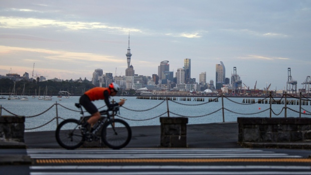 A cyclist rides past the city's skyline in Auckland, New Zealand, on Tuesday, Nov. 23, 2021. New Zealand's central bank is expected to raise interest rates for a second straight month and signal a more aggressive tightening cycle to contain inflation amid a labor shortage. Photographer: Brendon O'Hagan/Bloomberg