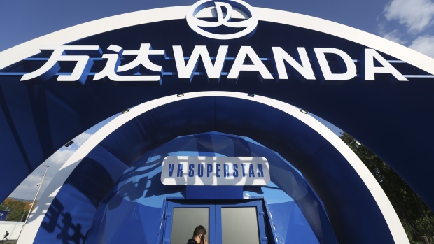 An employee stands by the promotional pavilion for the Dalian Wanda Group during preparations ahead of the FIFA World Cup outside the Luzhniki stadium in Moscow, Russia, on Wednesday, June 13, 2018. According to an April report from the organizing committee, the total amount spent on preparations is 683 billion rubles, or about $11 billion at the current exchange rate. Photographer: Andrey Rudakov/Bloomberg