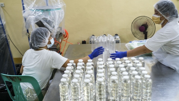 Workers pack bottles of cold-pressed coconut oil in Quezon province in 2021. Photographer: Veejay Villafranca/Bloomberg