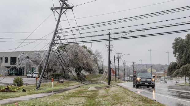 Frozen power lines hang near a sidewalk in Austin, Texas, on Feb. 1, 2023.