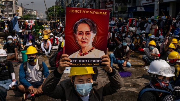 An anti-coup protester holds up a placard featuring Aung San Suu Kyi on March 02, 2021 in Yangon, Myanmar.
