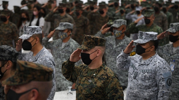 Philippine and US marines salute while their national anthems are played during the opening ceremony of "Kamandag" (cooperation of the warriors of the sea), a joint military exercise between US and Philippine marines at the Philippine marines headquarters in Taguig, suburban Manila on October 3, 2022.  Photographer: Ted Aljibe/AFP/Getty Images