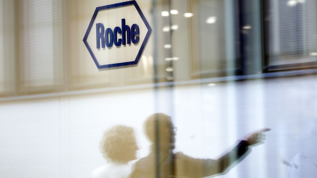 A company logo hangs on the wall at the Roche Holding AG headquarters in Basel, Switzerland, on Thursday, April 26, 2018. The world’s biggest maker of cancer treatments reported sales that exceeded analysts' estimates in the first quarter. Photographer: Stefan Wermuth/Bloomberg