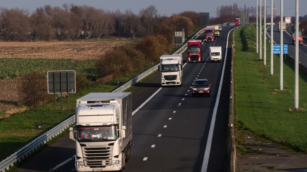Haulage trucks drive towards Calais, France, on the European E40 route highway in Gistel, Belgium, on Tuesday, Nov. 24, 2020. European Commission President Ursula von der Leyen said the coming days will be “decisive” for trade negotiations with the U.K. and crucial differences between the two sides remain.