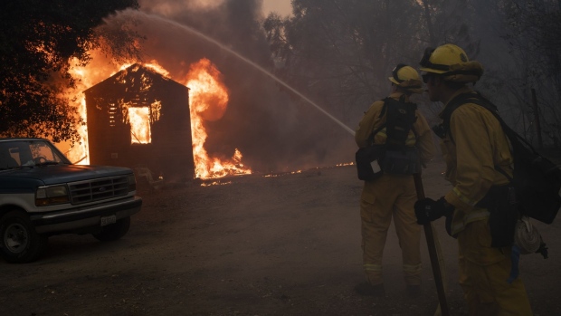 Firefighters work to prevent the fire from spreading during the Zogg fire near the town of Igo in Shasta County, California, U.S., on Sunday, Sept. 27, 2020. In Shasta County, the new, fast-spreading Zogg fire burned 7,000 acres by Sunday evening, prompting evacuations, according to the San Francisco Chronicle.