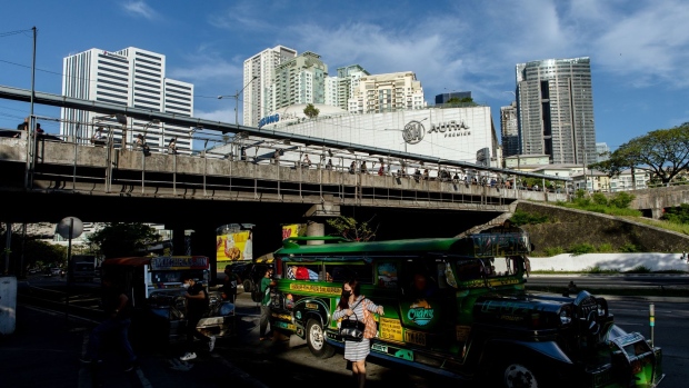 A passenger disembarks from a jeepney in Taguig City, Metro Manila, the Philippines, on March 22, 2022.The Philippines rate decision will be released March 24. Photographer: Geric Cruz/Bloomberg
