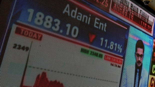 A screen displays Adani Group stock numbers inside the BSE building in Mumbai, India, on Thursday, Feb. 2, 2023. Adani’s businesses have lost $107 billion in a week, one of the biggest wipeouts in India’s history, after an explosive report by short-seller Hindenburg Research forced him to pull a stock sale at the 11th hour and led some lenders to reject his securities as collateral for client trades. Photographer: Dhiraj Singh/Bloomberg