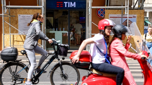 A cyclist passes a Telecom Italia SpA store in Rome, Italy, on Tuesday, May 31, 2022. Telecom Italia is seeking an enterprise value of around 20 billion euros ($21.5 billion) for the landline network it plans to sell to Italy’s state lender and a group of international funds, according to people with knowledge of the matter.
