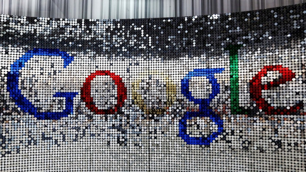 A sign featuring Google Inc.'s logo stands inside the entrance to their U.K. headquarters at Six St Pancras Square in London.