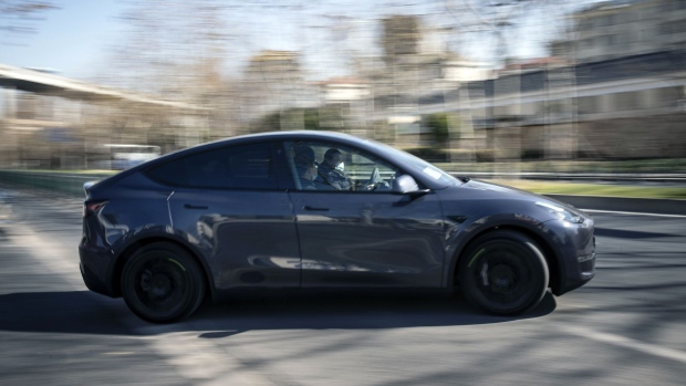 A Tesla Inc. Model Y electric vehicle leaves the automaker's showroom during a test drive in Shanghai, China, on Friday, Jan. 8, 2021. Tesla customers in China wanting to get the new locally made Model Y are facing a longer wait, signaling strong initial demand for the Shanghai-built SUV. Photographer: Qilai Shen/Bloomberg