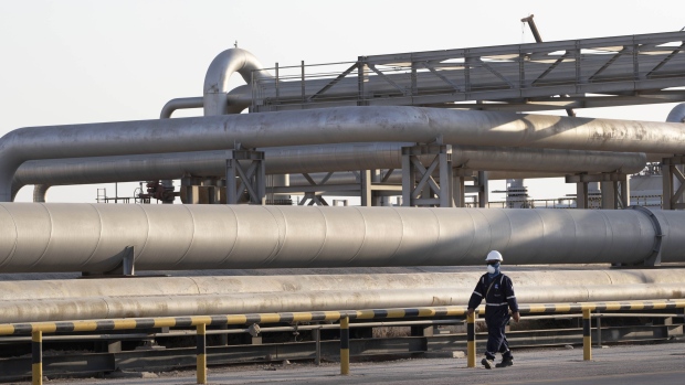 A worker passes oil transport pipes at Saudi Aramco's Abqaiq crude oil processing plant following a drone attack in Abqaiq, Saudi Arabia, on Friday, Sept. 20, 2019. Saudi Aramco revealed the significant damage caused by an aerial strike on its Khurais oil field and Abqaiq crude-processing plant last weekend, and insisted that the sites will be back to pre-attack output levels by the end of the month. Photographer: Faisal Al Nasser/Bloomberg