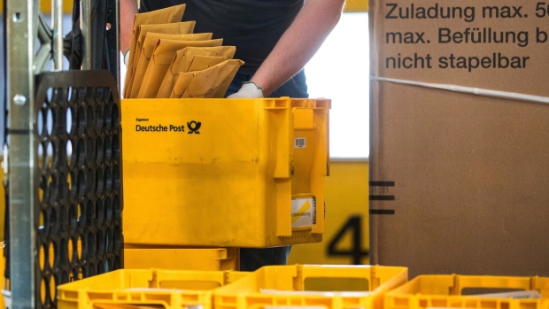 An employee sorts mail into cartons in a Deutsche Post AG sorting office in Berlin, Germany, on Monday, Aug. 2, 2021. Deutsche Post reports first half earnings on Aug. 5. Photographer: Krisztian Bocsi/Bloomberg