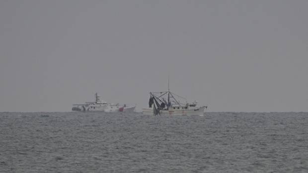 Ships scan the sea during efforts to retrieve and recover the Chinese spy balloon after Chinese spy balloon was shot down in Myrtle Beach SC, United States on February 05, 2023. Photographer: Peter Zay/Anadolu Agency/Getty Images