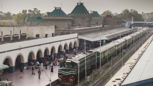 Passengers stand on a platform as a Green Line Express train, operated by Pakistan Railways between Islamabad and Karachi, sits at Rawalpindi railway station in Rawalpind, Pakistan, on Thursday, Feb. 22, 2018. Beijing is set to upgrade a 1,163-miles track from Karachi to Peshawar near the Afghan border with an $8 billion loan to Pakistan. It’s part of Chinese President Xi Jinping’s Belt and Road trade initiative, which includes $60 billion of badly-needed works financed in Pakistan.