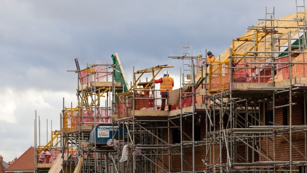 Employees on scaffolding at a Taylor Wimpey Plc residential housing construction site in Hoo, UK, on Monday, Jan. 9, 20233. Taylor Wimpey is due to give a trading update on Friday. Photographer: Chris Ratcliffe/Bloomberg