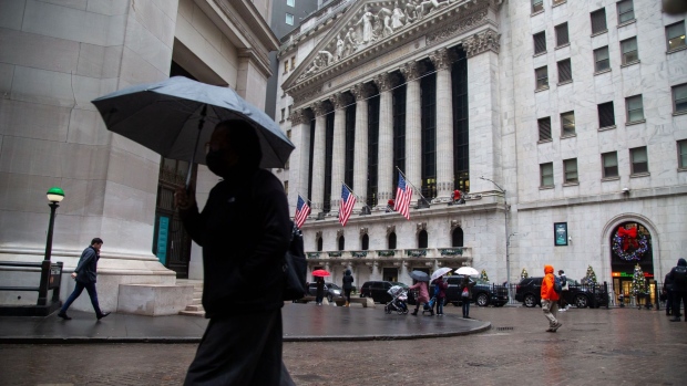 Pedestrians carry umbrellas in front of the New York Stock Exchange (NYSE) in New York, US, on Tuesday, Jan. 3, 2023. US stocks fell as losses in Apple Inc. and Tesla Inc. weighed on the S&P 500 and the tech-heavy Nasdaq 100.