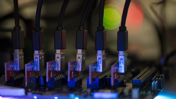 Blue data connector cables sit on a circuit board used in cryptocurrency mining machines at the SberBit mining 'hotel' in Moscow, Russia, on Saturday, Dec. 9, 2017. Futures on the world’s most popular cryptocurrency surged as much as 26 percent in their debut session on Cboe Global Markets Inc.'s exchange, triggering two temporary trading halts designed to calm the market. Photographer: Andrey Rudakov/Bloomberg