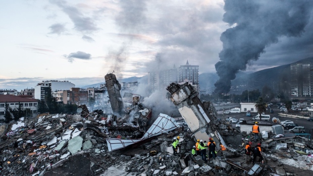 HATAY, TURKEY - FEBRUARY 07: Smoke billows from the Iskenderun Port as rescue workers work at the scene of a collapsed building on February 07, 2023 in Iskenderun, Turkey. A 7.8-magnitude earthquake hit near Gaziantep, Turkey, in the early hours of Monday, followed by another 7.5-magnitude tremor just after midday. The quakes caused widespread destruction in southern Turkey and northern Syria and were felt in nearby countries. (Photo by Burak Kara/Getty Images)