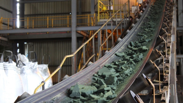 A conveyor belt moves raw cobalt for processing at the Etoile mine, operated by Chemaf Sarl, in Katanga province near Lubumbashi, the Democratic Republic of Congo, on Wednesday, Dec. 22, 2021. Along a 250-mile highway which cuts through central Africa, thousands of flatbed trucks haul sheets of copper and sacks of cobalt hydroxide, essential for electric cars and other 21st century technologies for which drivers must pay steep tolls, as much as $900 for a round trip.
