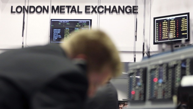A trader uses a telephone as he works on the trading floor outside the open outcry pit at the London Metal Exchange (LME) in London, U.K., on Tuesday, Feb. 3, 2015. The London Metal Exchange, once located above a hat shop in the city's financial district, will move Europe's last trading floor to a new building by next year. Photographer: Chris Ratcliffe/Bloomberg