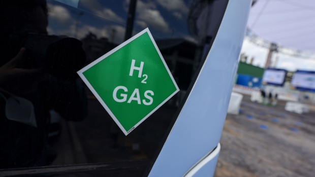 A chemical symbol on a hydrogen powered bus at the Wesseling green hydrogen refinery, operated by Royal Dutch Shell Plc, in Wesseling, Germany, on Friday, July 2, 2021. Europe is pinning its green hopes on hydrogen in an unprecedented economic overhaul that aims for the region to reach climate neutrality by 2050. Photographer: Alex Kraus/Bloomberg