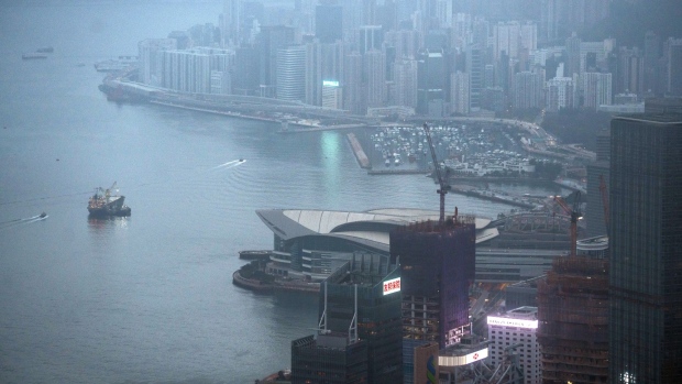 Buildings shrouded in fog in Hong Kong, China, on Monday, Feb. 6, 2023. The border between Hong Kong and China fully reopened marks a step in Hong Kong’s bid to rebuild its reputation as a business hub connecting mainland China and the rest of the world, and comes days after Chief Executive John Lee unveiled a publicity campaign to revive the economy and welcome back visitors. Photographer: Lam Yik/Bloomberg
