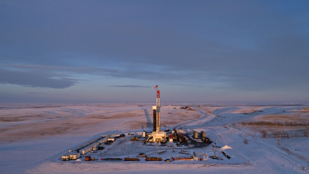 An American flag flies on top of a Unit Drilling Co. rig in the Bakken Formation in this aerial photograph taken outside Watford City, North Dakota, U.S., on Friday, March 9, 2018. When oil sold for $100 a barrel, many oil towns dotting the nation's shale basins grew faster than its infrastructure and services could handle. Since 2015, as oil prices floundered, Williston has added new roads, including a truck route around the city, two new fire stations, expanded the landfill, opened a new waste water treatment plant and started work on an airport relocation and expansion project. Photographer: Daniel Acker/Bloomberg