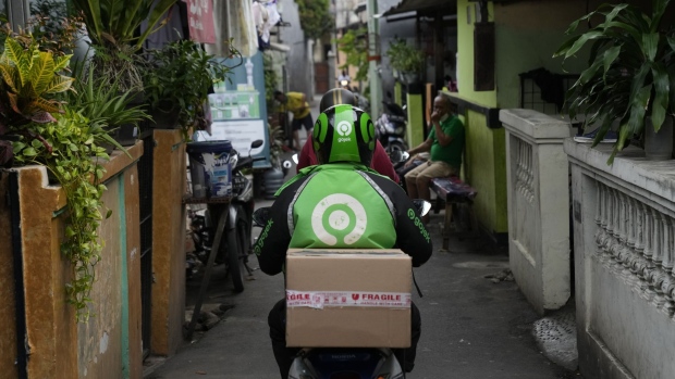 A Gojek driver delivers a PT Tokopedia order in Jakarta, Indonesia, on Friday, April 8, 2022. GoTo, formed through the merger of Gojek with e-commerce pioneer Tokopedia, raised $1.1 billion in one of the world’s biggest stock debuts this year and is slated to list in Jakarta April 11. Photographer: Dimas Ardian/Bloomberg