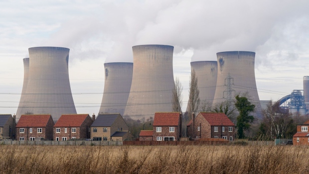 Residential housing near cooling towers at Drax Power Station, operated by Drax Group Plc, where coal-fired units 5 and 6 have been put on standby to generate electricity supplies during a cold snap, near Selby, UK, on Monday, Jan. 23, 2023. Drax Power station is one of three stations that negotiated a winter contingency contract with National Grid Plc for this winter following a request from the government.