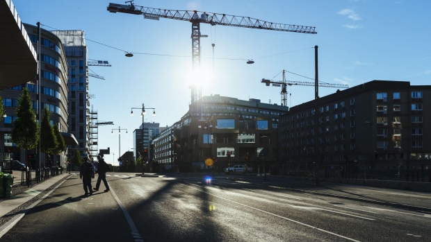 Construction cranes operate at the site of the Hagastaden urban project, one of the city's largest development sites, in Stockholm, Sweden, on Wednesday, June 28, 2017. Just as Sweden’s biggest mortgage banks start raising interest rates, the country’s state-backed home-loan provider says it’s cutting customers’ borrowing costs in a move that threatens to hurt industry profits after years of negative rates. Photographer: Mikael Sjoberg/Bloomberg