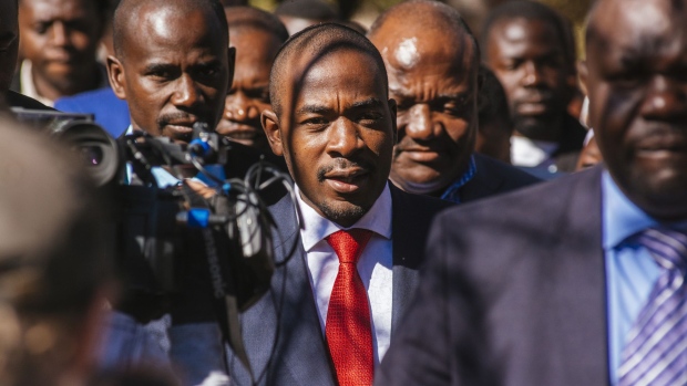 Nelson Chamisa, leader of the Movement for Democratic Change (MDC), center, arrives to cast his vote at a polling station in the Kuwadzana township, in Harare, Zimbabwe, on Monday, July 30, 2018. After nearly two decades of political turmoil, a credible vote would help provide the southern African nation with a foundation to begin rebuilding its battered international reputation and an economy largely laid to ruin during the latter half of Robert Mugabe's 37-year rule.