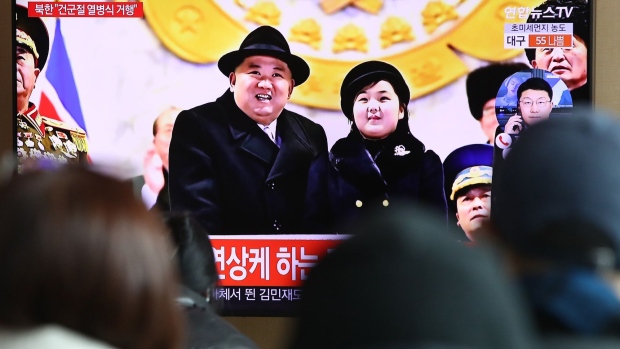 A brodcast showing Kim Jong Un and his daughter during North Korea's 75th anniversary of the founding of the armed forces day military parade released by Korean Central News Agency (KCNA) at the Seoul Railway Station on Feb. 9. Photographer: Chung Sung-Jun/Getty Images